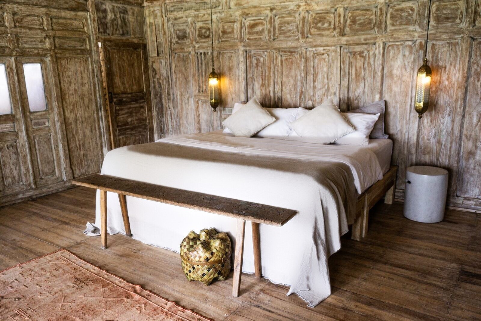 Standard bungalow with a king bed and carved wooden walls