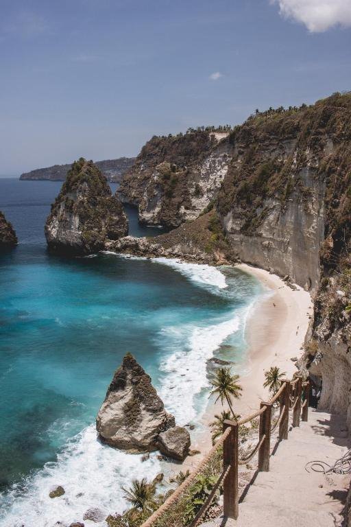The stairs down to Diamond Beach, with turquoise water and limestone cliffs