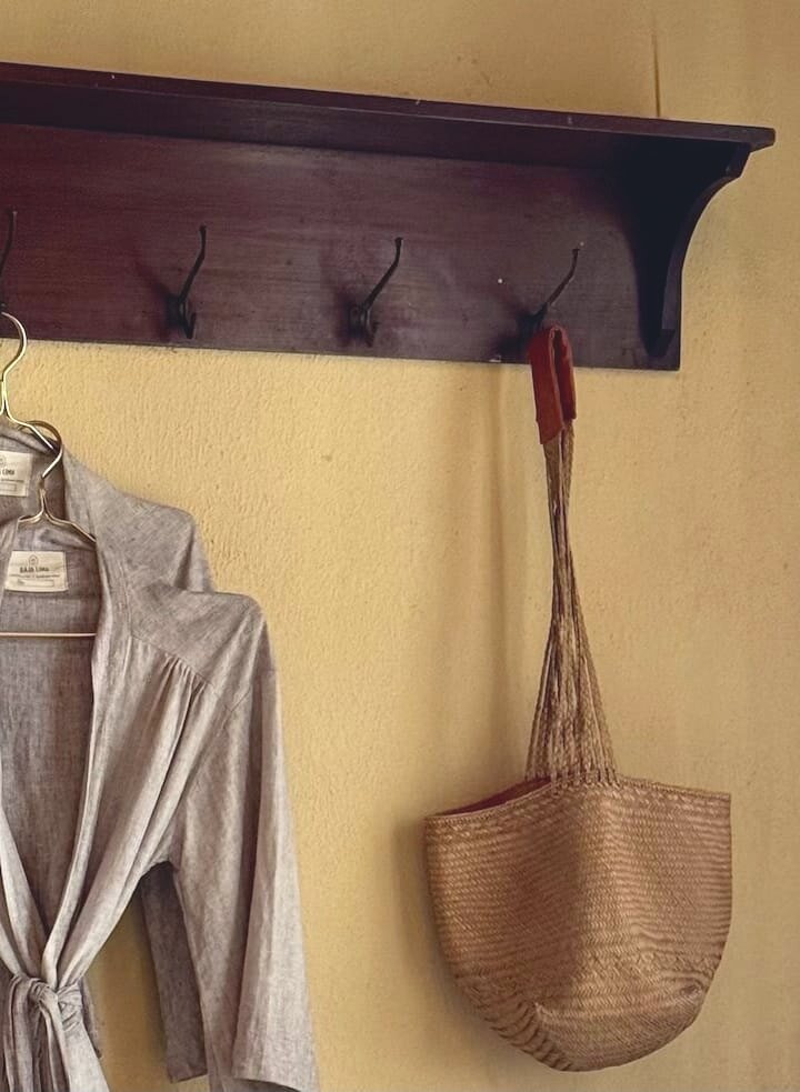 Raja Lima linen robe and a woven basket on the wall hooks
